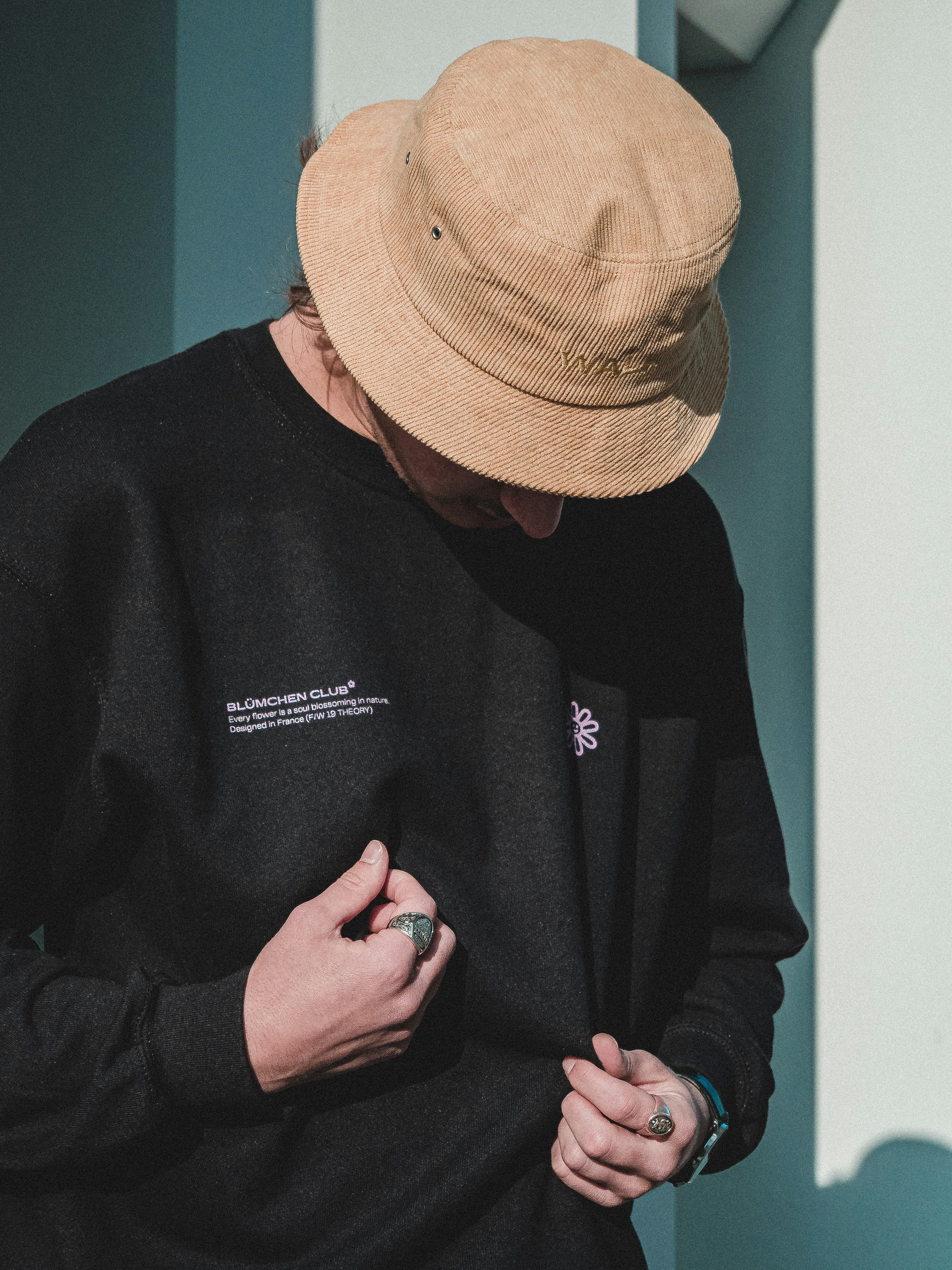 Editorial portrait — natural light, layered earth tones.